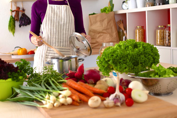 Young Woman Cooking in the kitchen. Healthy Food