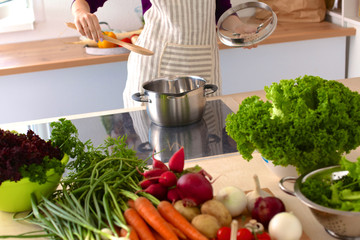 Young Woman Cooking in the kitchen. Healthy Food