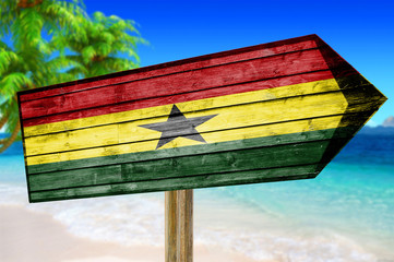 Ghana Flag wooden sign on beach background