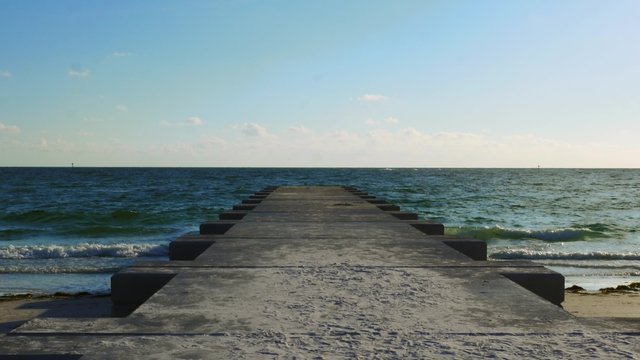 Concrete dock leading into ocean, 4K