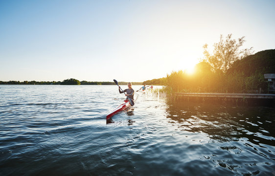 Woman kayaking in the sunset