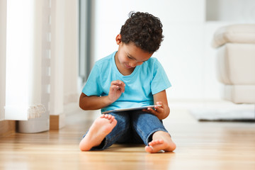 African american little boy using a tactile tablet
