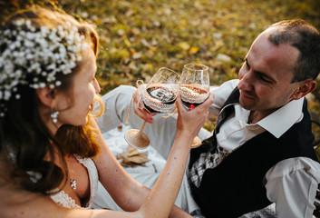 Beautiful wedding couple at a picnic under tree