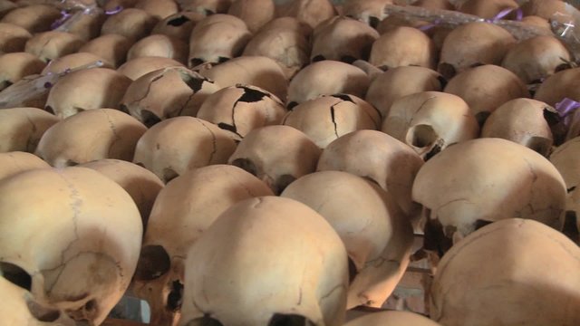 Pan across hundreds of skulls crushed during the genocide in Rwanda.