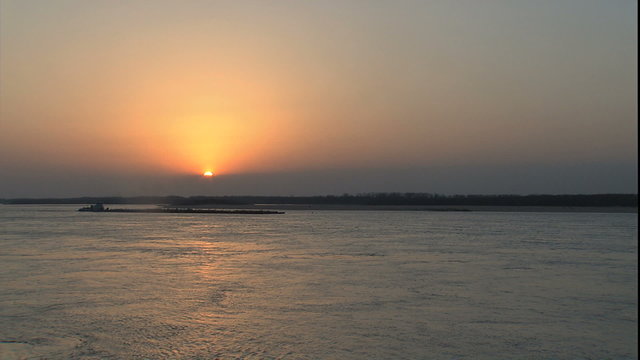 Mississippi river as sun sets into fog