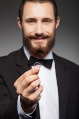 Attractive young bearded man is carrying jewelry