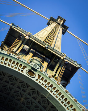 Architectural detail of painted steel tower of the Manhattan Bridge. The long-span suspension bridge crosses New York City’s East River linking Downtown Manhattan and Brooklyn
