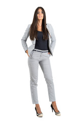 Sexy confident bossy businesswoman with hands in pockets looking at camera