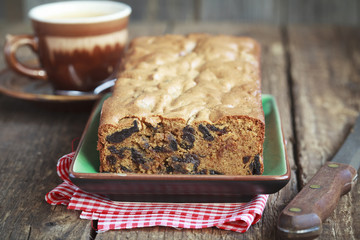 Cake with prunes and almond flour on a old wooden table 