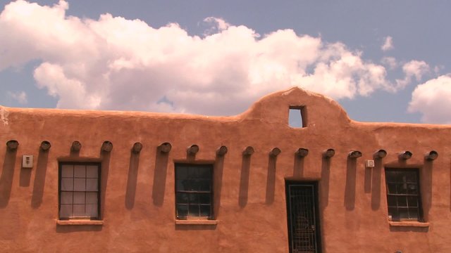 Time lapse clouds above a New Mexico adobe building.