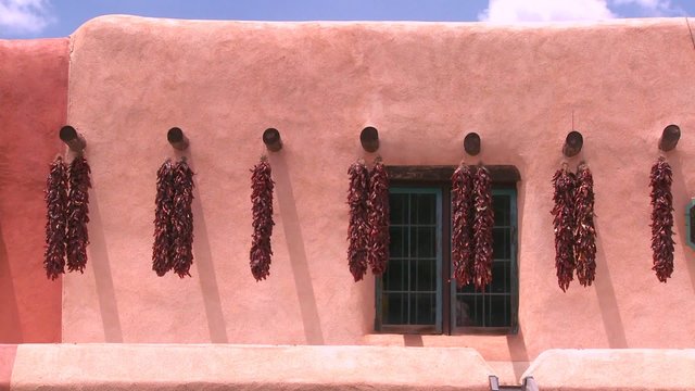 Chili peppers hang outside a New Mexico building in Taos.