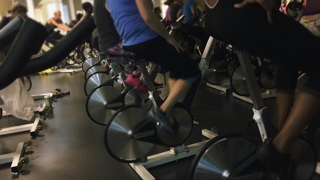 Group of people pedaling fast during a spinning class