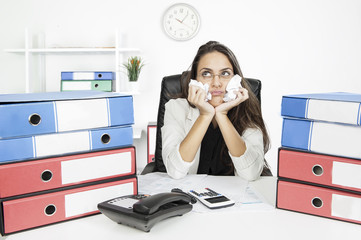 Bored young businesswoman at the desk