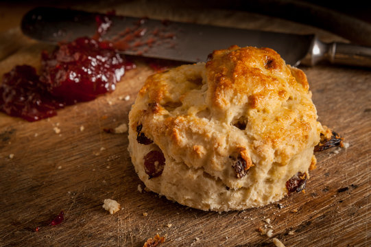 Homemade scone with strawberry jam ready to eat.