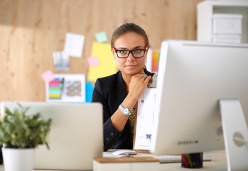 Portrait of an attractive young businesswoman sitting in front