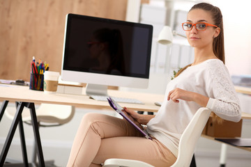 Portrait of an attractive young businesswoman sitting in front