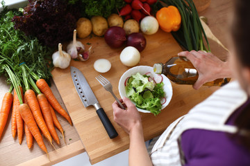 A young woman cooking in the kitchen.