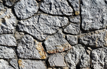 Dark gray wall made of stacked rocks 