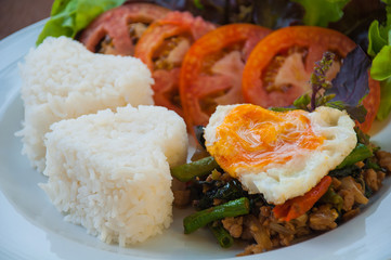 Rice topped with stir-fried pork and basil with egg, Thai style