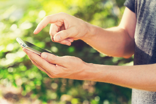 Young Man On His Smartphone Outside