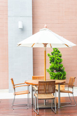 Table and chair with white umbrella outdoor patio