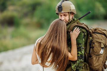 woman and soldier in military uniform say goodbye