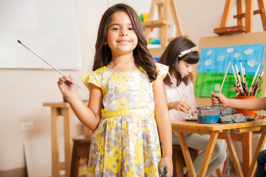 Little female artist enjoying art class