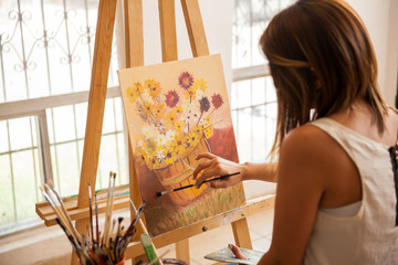 Female artist finishing a painting