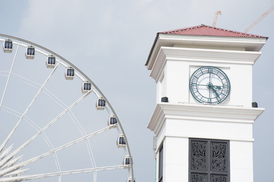 Clock tower and Ferris wheel in background