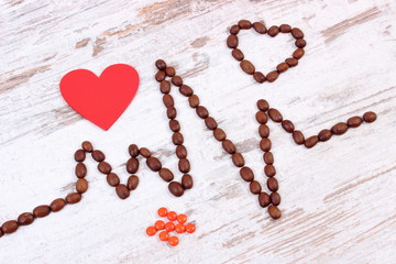 Cardiogram line of coffee grains, red heart and supplement pills, medicine and healthcare concept