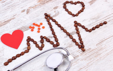 Cardiogram line of coffee grains, stethoscope and supplement pills, medicine and healthcare concept