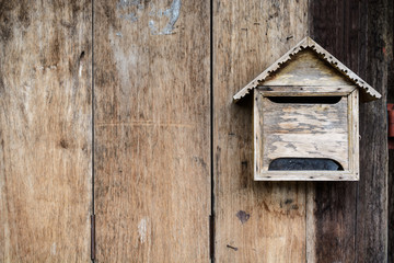 Old wooden mailbox with old vintage wooden background