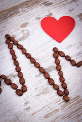 Cardiogram line of roasted coffee grains and red heart, medicine and healthcare concept