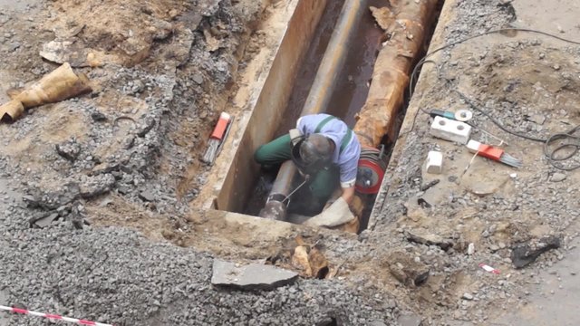 Man repairing heating pipes, above view