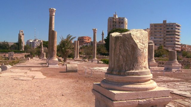 The Roman ruins of Tyre with the modern city background.