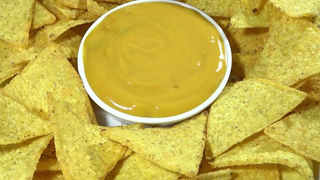 Rotating Nachos with cheese dip (seamless loopable 4K UHD footage)