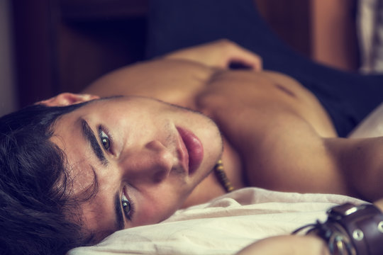 Shirtless Sexy Male Model Lying Alone On His Bed