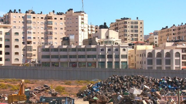 Panning shot of Palestinian buildings near the Israeli West Bank barrier between Israel and Palestinian territories