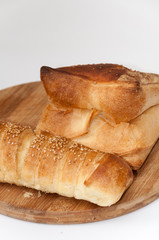 Hot dog bun and pastry on the wooden board