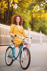 Beautiful young woman on a bike in the city