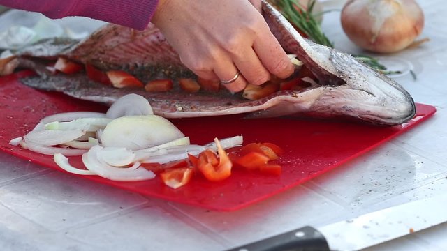 Preparation rainbow trout process, cutting onion for seasoning
