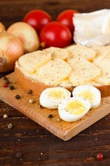 Three halves of quail eggs on chopping board