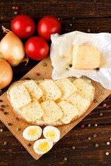 Top view on board with eggs bread and vegetable
