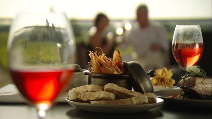 Footage of romantic couple alfresco fine dining meal outdoors amongst vineyards in winery with wine on table, seafood menu with vine views. Australian tourism in Barossa, Clare, Hunter, Yarra, Valley