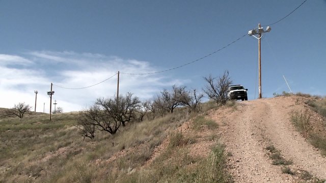 A vehicle sits on a path in a remote area.
