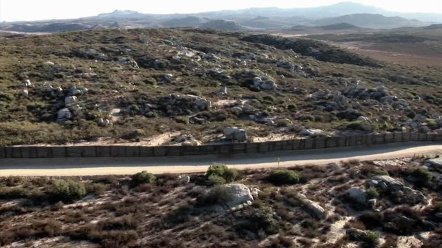 Aerial reconnaissance is being performed on a long stretch of border fence.