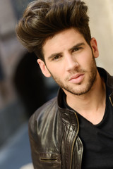 Obraz premium Attractive young handsome man, model of fashion in urban backgro