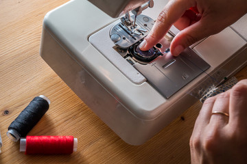 women sewing with sewing machine 