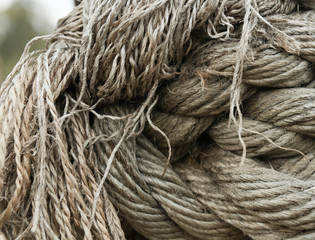 Knots and fibers of old ship rope closeup view