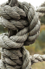 Fototapeta na wymiar Strong knot of time-worn ship rope